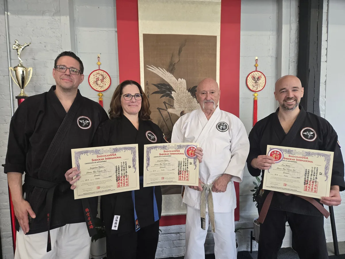 Black belts holding their ShidokanUSA rank certificates